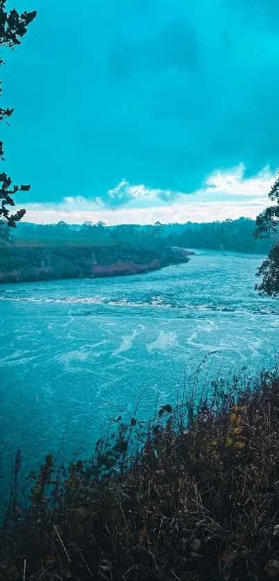 Tranquil river and tree-lined landscape with vibrant blue tones.