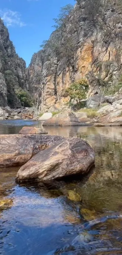 Serene river flowing through a canyon with rocky cliffs.