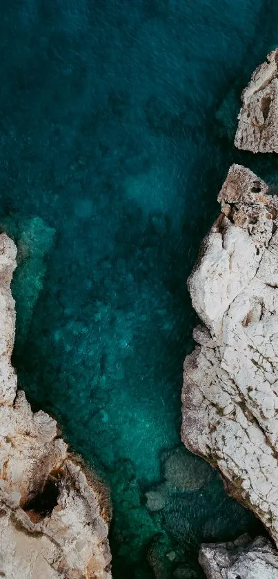 Deep blue waters meet rugged coastline in this serene mobile wallpaper.
