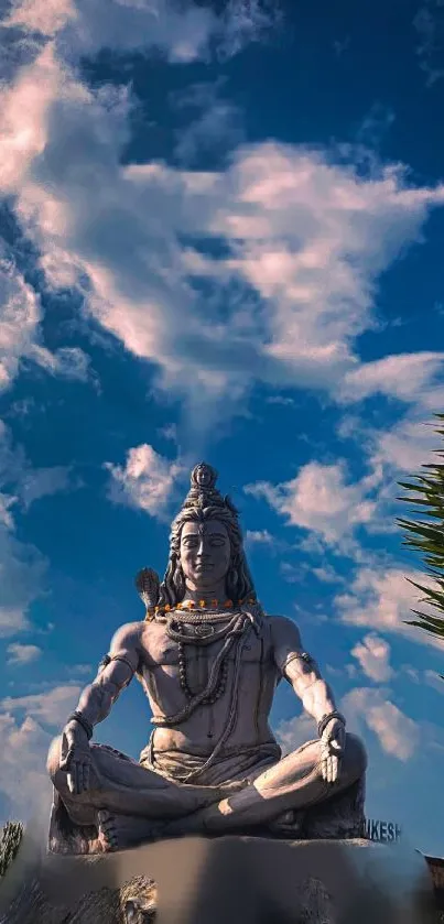 Lord Shiva statue under blue sky with clouds