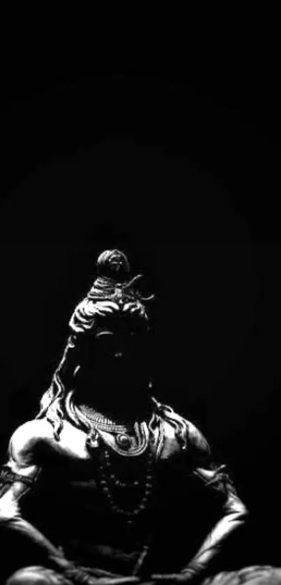 Silhouette of Shiva against black background, meditation theme.