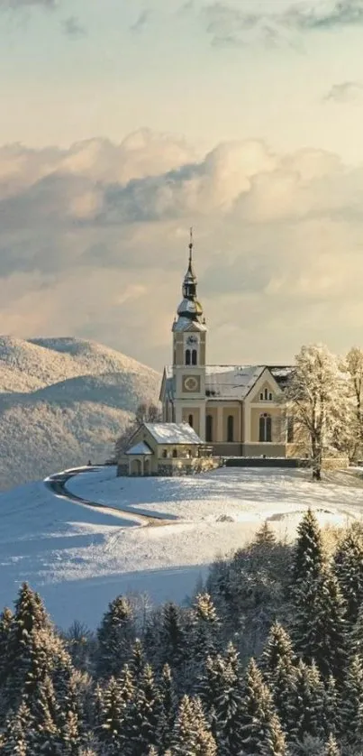 Serene snowy church on a hill with sunset sky.