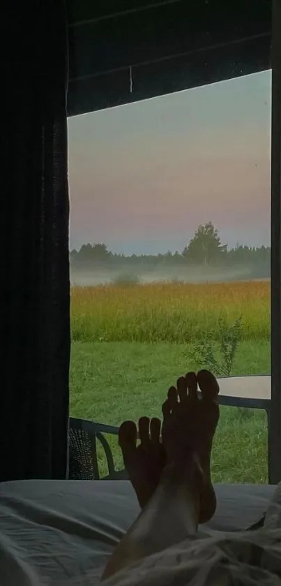 Cozy bedroom view with sunset and misty field for serene mobile wallpaper.