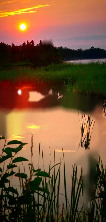 Serene sunset over a calm lake with vibrant orange sky.