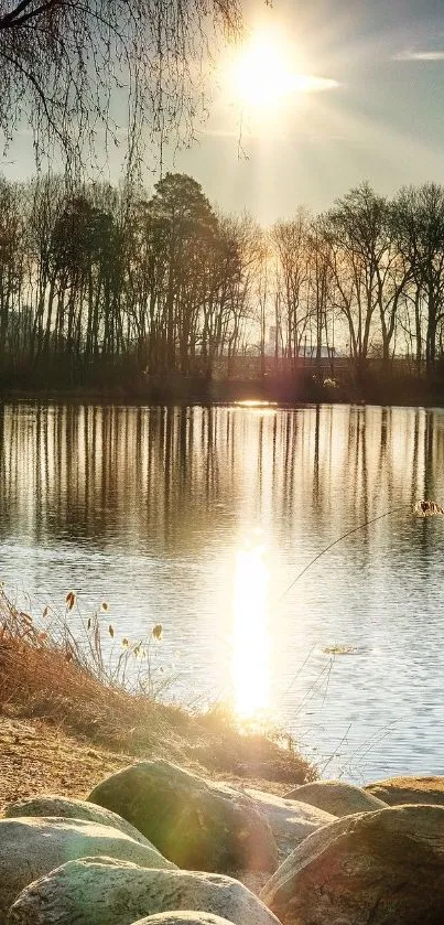 Sunset over a tranquil lake with trees reflecting in the water.