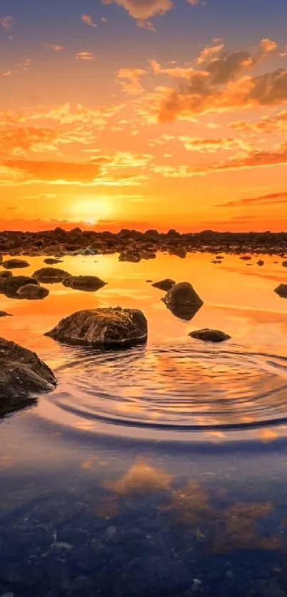 Serene sunset reflecting over a tranquil lake with rocks and evening sky.