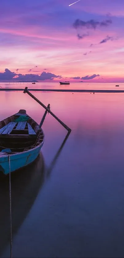 A tranquil lake at sunset with vivid purple and pink colors and a lone boat.