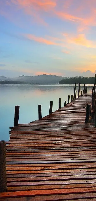 Peaceful pier at sunset with reflections on calm water and colorful sky.