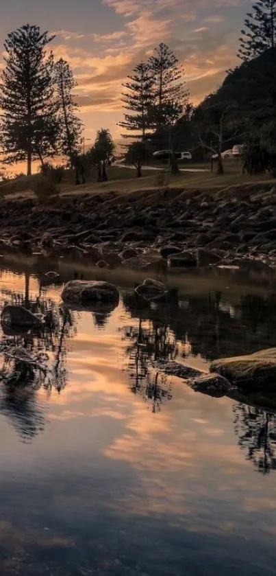 Calming river scene at sunset with tree reflections and twilight sky.