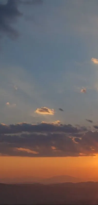 Serene sunset with clouds and a vibrant sky.