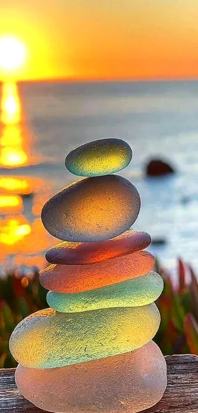 Colorful glass stones stacked by a serene sunset beach.