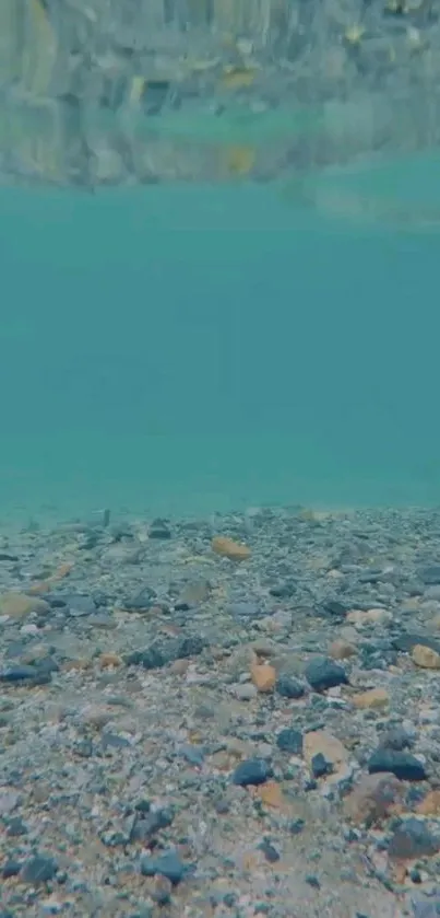 Serene underwater wallpaper featuring turquoise sea and pebbled seabed.