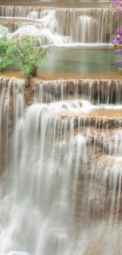 Cascading waterfall with vibrant purple flowers wallpaper.