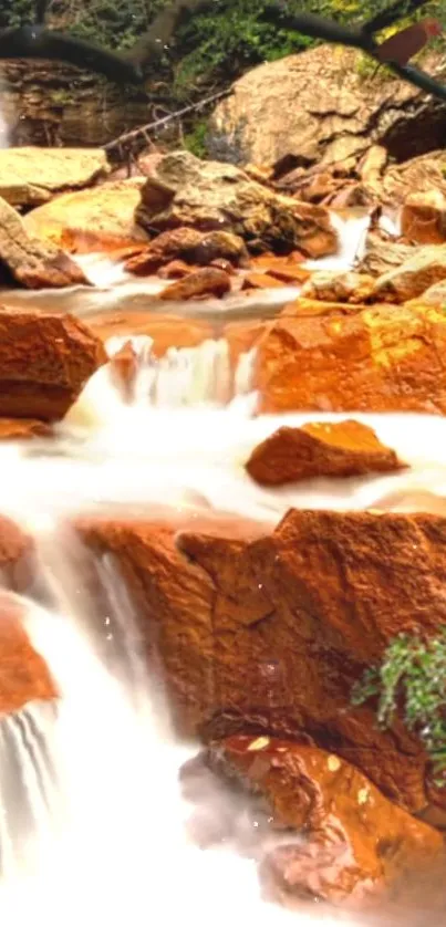 Serene waterfall flowing over brown rocks surrounded by lush greenery.