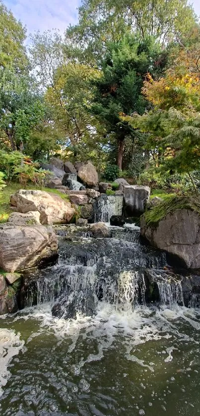 Tranquil waterfall with lush greenery and vibrant foliage in natural setting.