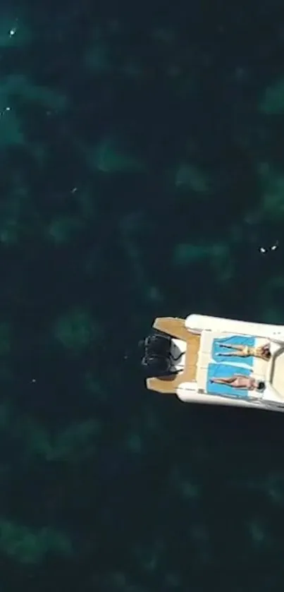 Aerial view of a luxury yacht floating on deep blue ocean waters.