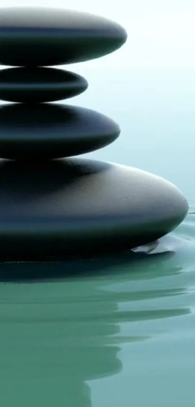 Zen stone stack on calm water, serene wallpaper.