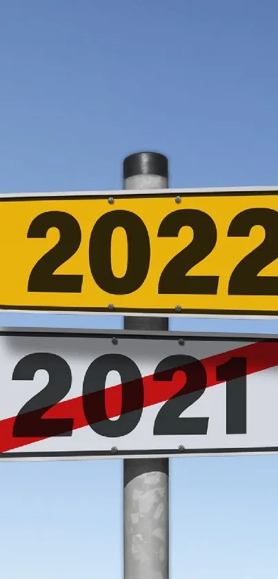 Street sign showing change from 2021 to 2022 against clear sky.