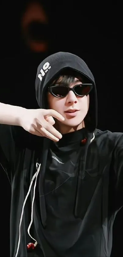 Black hoodie with sunglasses on a stylish figure, exuding a trendy vibe.