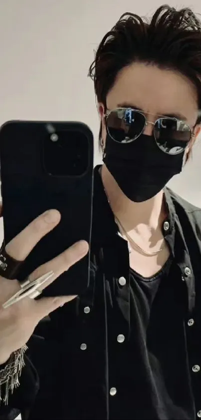 Sleek black outfit mirror selfie with accessories and sunglasses.