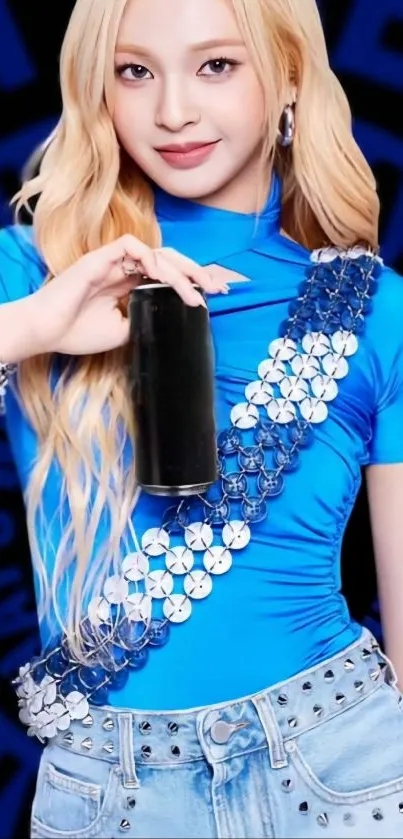 Stylish woman in blue outfit holding a beverage.