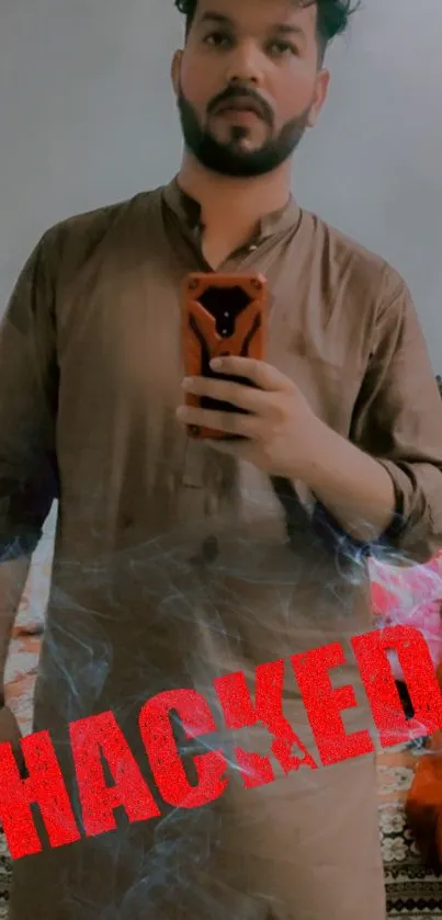 Wallpaper with 'Hacked' text over a selfie in brown attire.