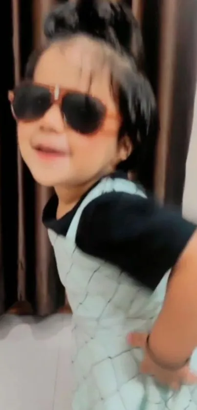 Cute kid wearing sunglasses with a stylish pose.