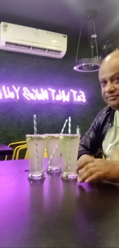 Vibrant cafe setting with neon lights and refreshing drinks on a table.