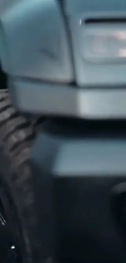 Close-up of an off-road truck showcasing its rugged tire and metallic body.