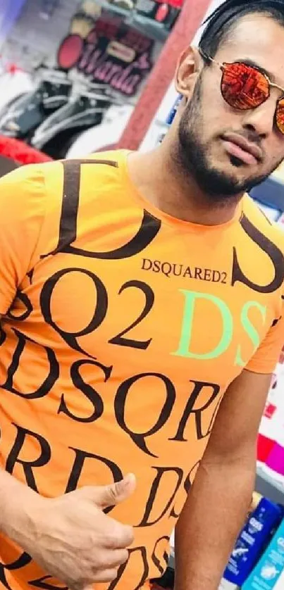 Man in trendy orange t-shirt with sunglasses in a store.