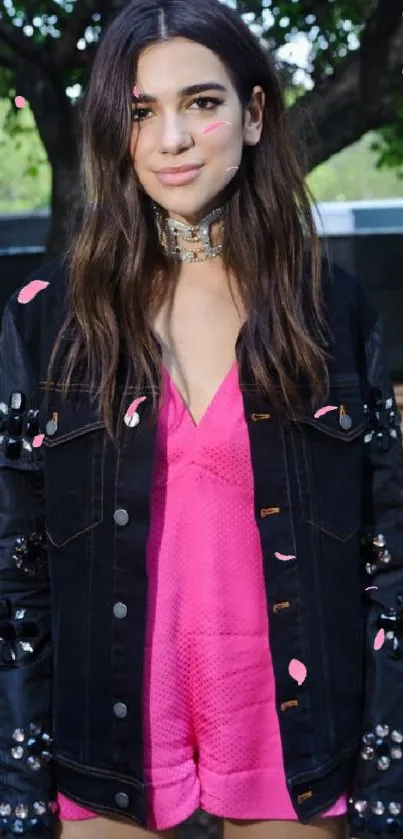 Fashionable woman in black jacket and pink outfit outdoors.