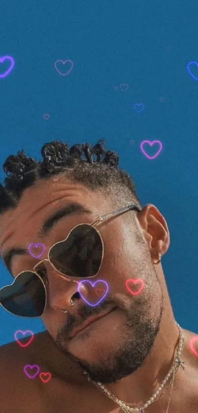 Man with heart-shaped sunglasses, blue backdrop.