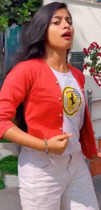 Woman in stylish red and white outfit, outdoors.