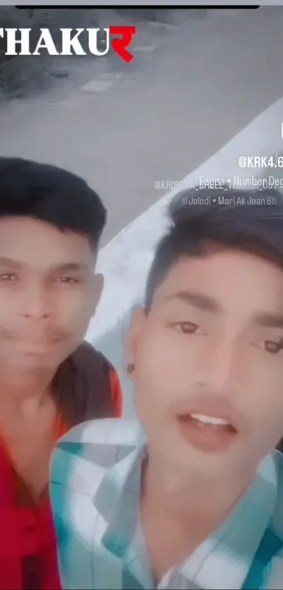 Two young men in trendy urban fashion pose stylishly for a photo.