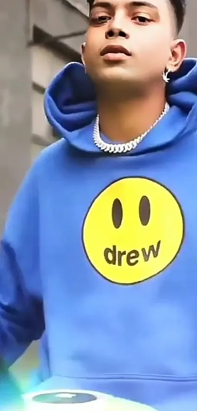 Vibrant blue urban hoodie with smiley face design.