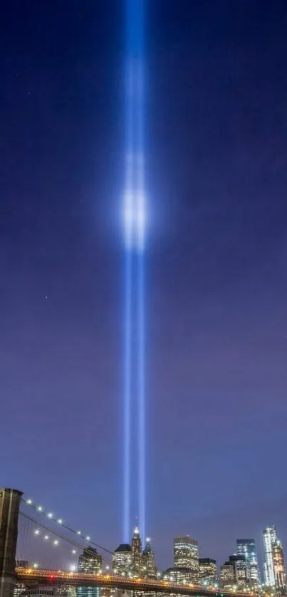 Tribute in Light shines over New York skyline at night.