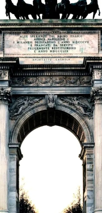 Triumphal arch with sculptures at sunset.