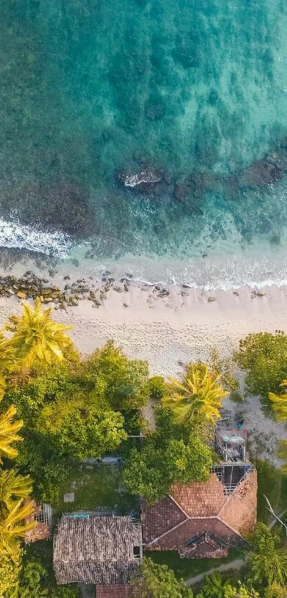 Aerial view of a tropical beach with turquoise water and lush greenery.