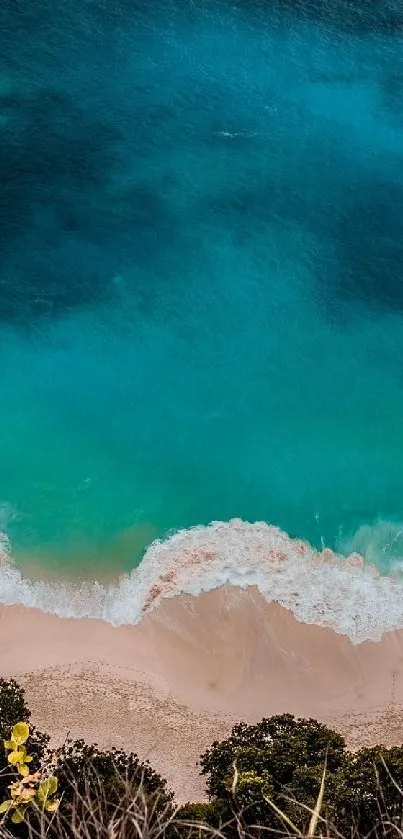 Aerial view of a serene beach with turquoise waves and sandy shore.