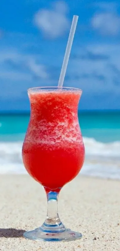 Tropical drink on beach with ocean backdrop.