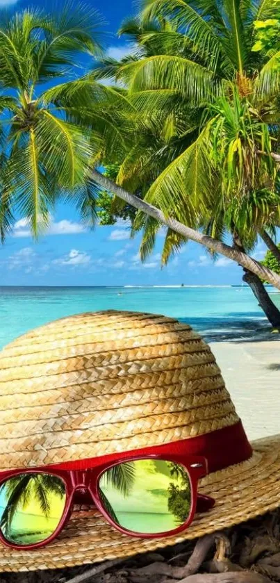 Straw hat and sunglasses on a tropical beach with palm trees.