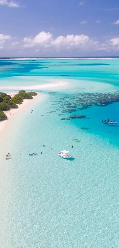 Aerial view of a tropical beach with clear aqua blue water and sandy shoreline.