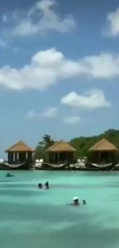 Tropical beach with turquoise water and overwater bungalows.