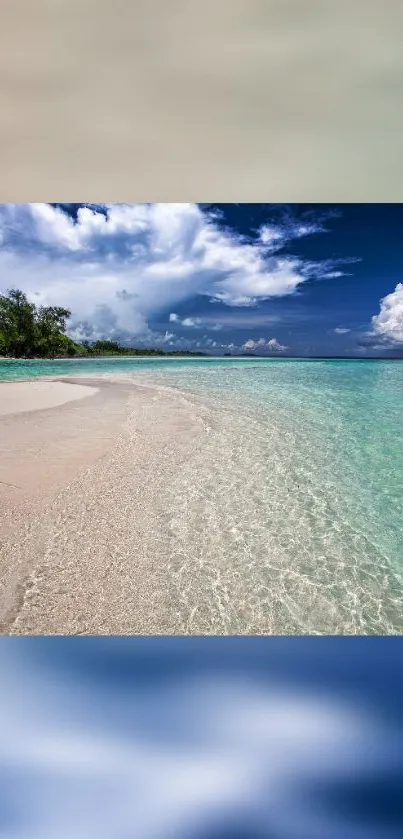 Tropical beach with azure blue water and cloudy sky on a sunny day.