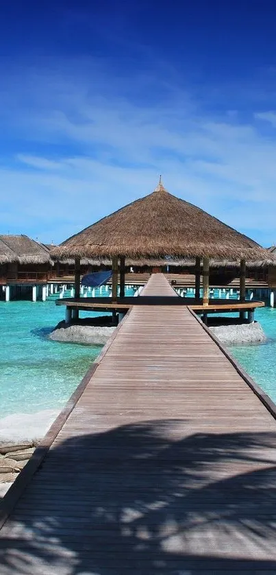 Beautiful tropical beach with turquoise water and a wooden pier under a blue sky.