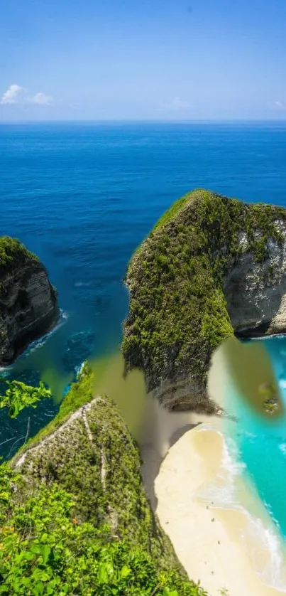 Tropical beach with clear blue ocean and lush green cliffs.