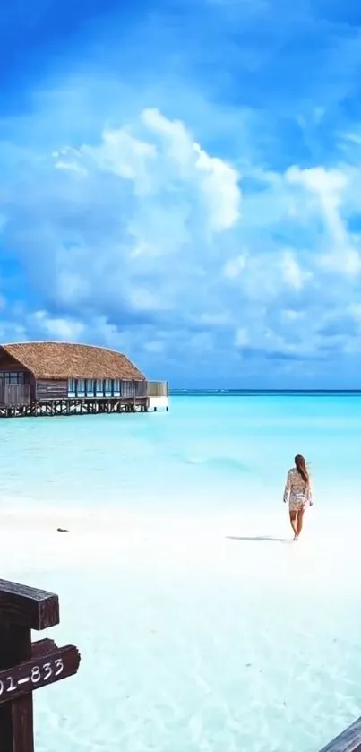 Tropical beach scene with azure sky, a wooden house on stilts, and a woman walking.