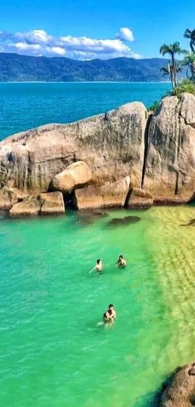 Scenic tropical beach with turquoise water and rocky shoreline.