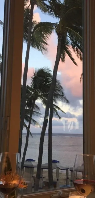 Tropical beach view through a window with palm trees at sunset.