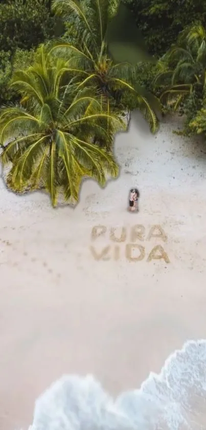 Tropical beach with palm trees and 'Pura Vida' in the sand.